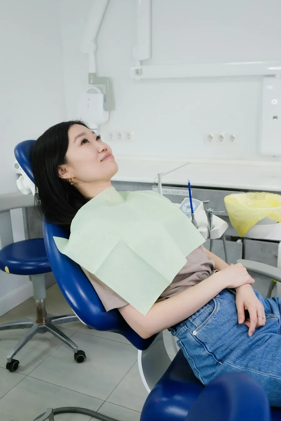 A woman relaxed and comfortable in a dental chair at Taki Dent Antalya — the calm, patient-centred environment that makes UK patients feel at ease throughout treatment